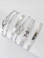 Six silver bangles with engraved details and smooth finish