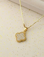 Dainty clover pendant necklace on white background