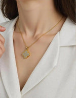 Reversible pendant necklace showing both sparkling and black sides