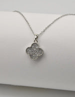 Dainty clover silver pendant necklace on white background