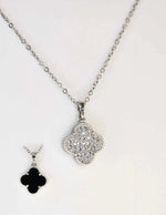 Reversible pendant necklace showing both sparkling and black sides