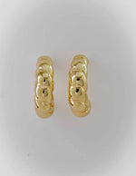 Bold twisted gold earrings with high-polish shine