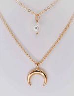 Double strand gold necklace featuring moon and pearl pendants