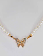 Layered pearl necklace with sparkling butterfly pendant