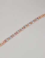 radiant_twilight_permanent_bracelet – american jewelry rose gold bracelet with baguette crystals on shell background