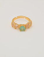 sea_mist_adjustable_ring_front_view – premier jewelry canada adjustable ring with sea mist green stone and baguette accents