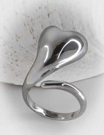 Silver ring with a unique design on a textured surface