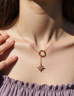 Delicate cross necklace featuring celestial charm and gold ring