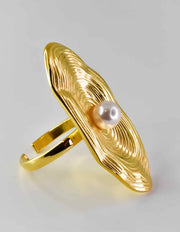 Front view of 14k gold ring with central pearl on oval base