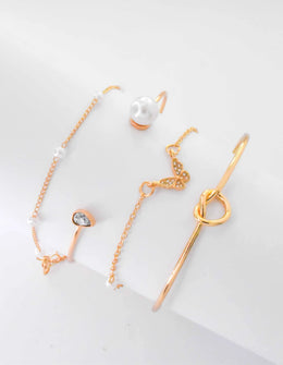 Stack of gold bracelets for women with pearls and butterfly charm