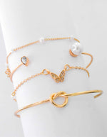 Butterfly charm bracelet paired with dainty gold bar detail