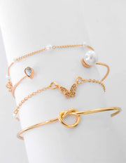 Butterfly charm bracelet paired with dainty gold bar detail
