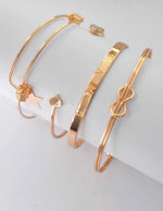 Dainty heart and star charms in gold bangle bracelet