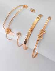 Dainty heart and star charms in gold bangle bracelet