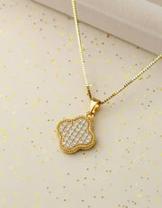 Dainty clover pendant necklace on white background