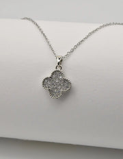 Dainty clover silver pendant necklace on white background
