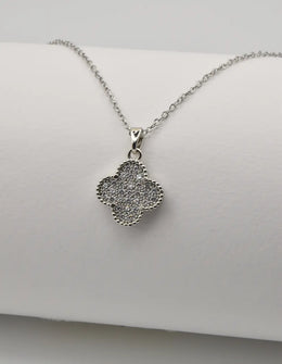 Dainty clover silver pendant necklace on white background