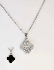 Reversible pendant necklace showing both sparkling and black sides