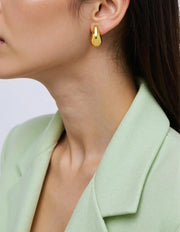 Model wearing clean girl style teardrop hoop earrings