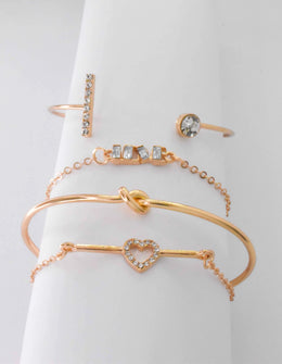 Gold couple bracelets featuring sparkling heart centre charm