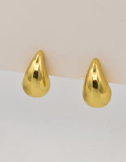 Molten gold hoop earrings with teardrop shape close-up