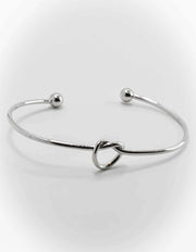 Gift-ready charm bracelet set stacked on white roll