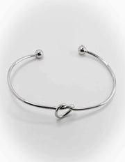 Dainty charm bracelets for women styled with gold cuffs