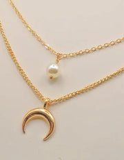 dainty gold layered necklace with moon and pearl accents