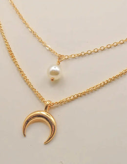 dainty gold layered necklace with moon and pearl accents