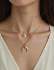 Gold layered pendant necklace with pearl and crescent charms