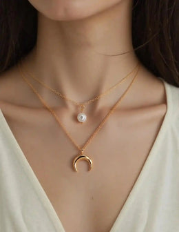 Gold layered pendant necklace with pearl and crescent charms