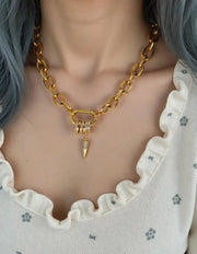 Close-up of crystal-studded spike on chunky chain