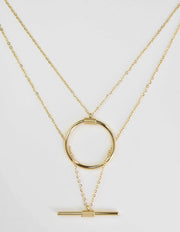dainty gold necklace featuring circular and horizontal bar
