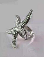 Silver starfish ring styled with minimalist cuffs