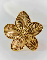 Gold blooming petal ring with detailed floral engraving on white