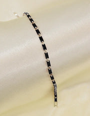delicate_black_link_chain_bracelet_on_satin_background_minimalist_canadian_style