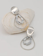 close up of gold dangly earrings featuring clear baguette crystals, montreal jewellery gift for her