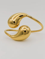 Gold bracelet with a unique design on a light gray background
