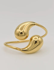 Montreal-inspired flat lay of gold teardrop bracelet with pearls