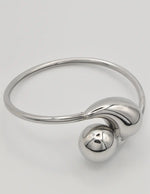 Silver bracelet with a unique design on a light gray background