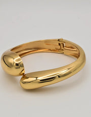 dual hoop bangle in gold stacked with minimalist chain bracelets