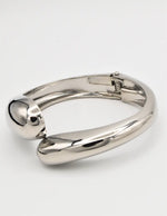 Silver metallic bangle on a white background