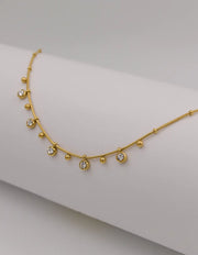 Minimalist gold necklace with dainty zircon and bead charms