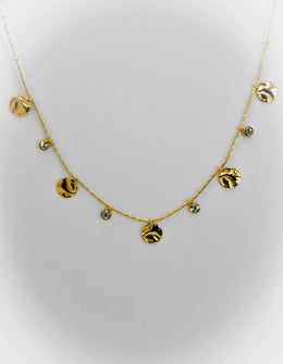Dainty gold necklace with hammered coins and zircon drops on white background
