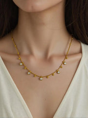 Peoples jewelry necklace with polished gold beads and sparkle stones