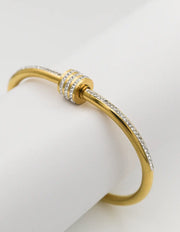Side view of gold arm bracelet with zircon detailing