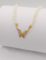 delicate_pearl_and_gold_butterfly_necklace_displayed_on_white_background