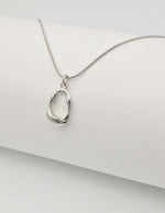 minimalist gold chain with a sleek round pendant inspired by montreal style