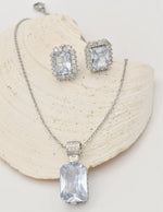 radiant_glamour_silver_set sterling silver necklace and crystal earrings displayed on shell, montreal minimalist jewelry gift for her