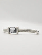 “Statement silver bracelet with red crystal centre, sleek loom band, and Canadian jewellery craftsmanship.”